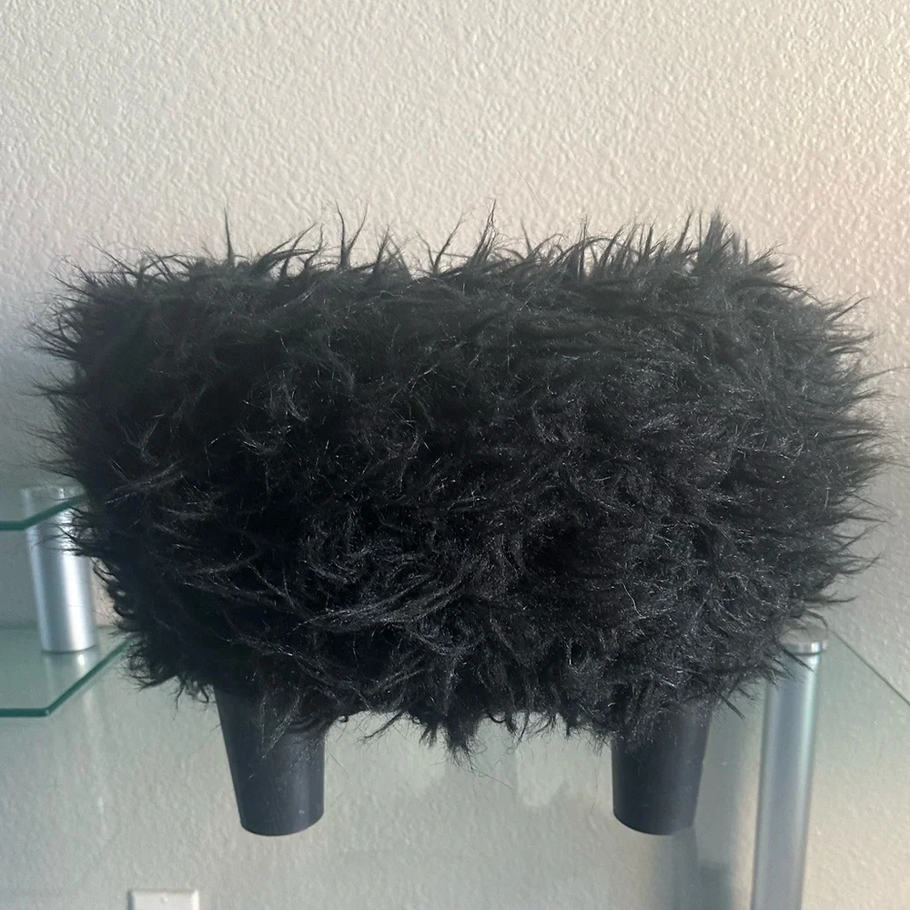 black faux fur ottoman/stool with 3 wooden legs